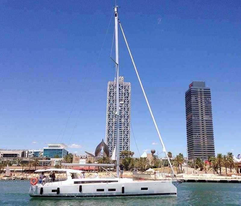 a boat sailing on the water with Spinnaker Tower in the background aboard SIRIUS Yacht for Charter