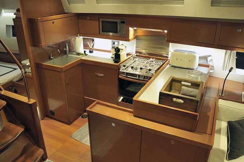 a kitchen with wooden cabinets aboard SIRIUS Yacht for Charter