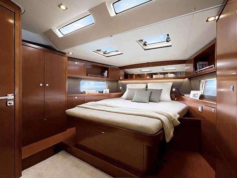 a room with a bed and a desk aboard SIRIUS Yacht for Charter