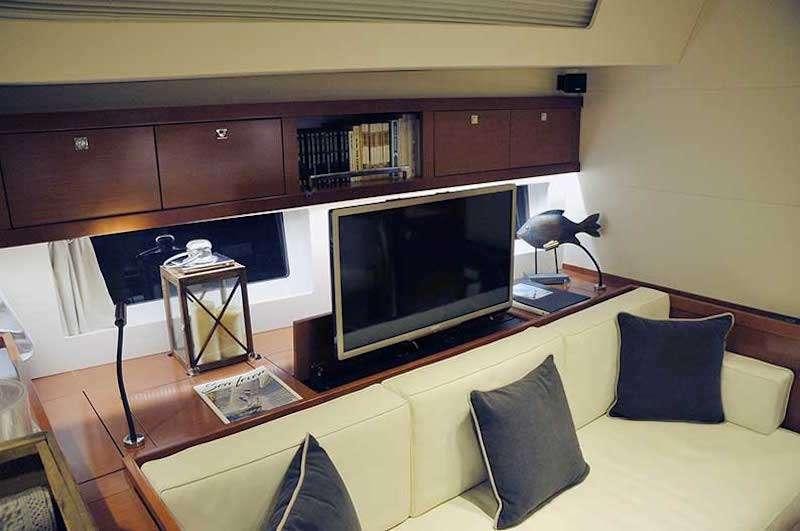 a living room with a tv and a couch aboard SIRIUS Yacht for Charter