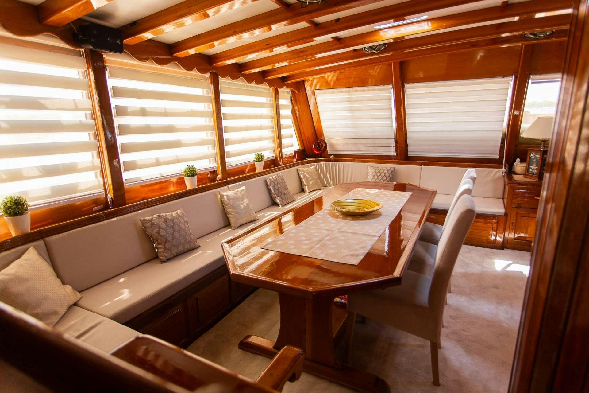 a room with a table and chairs aboard KADENA Yacht for Charter