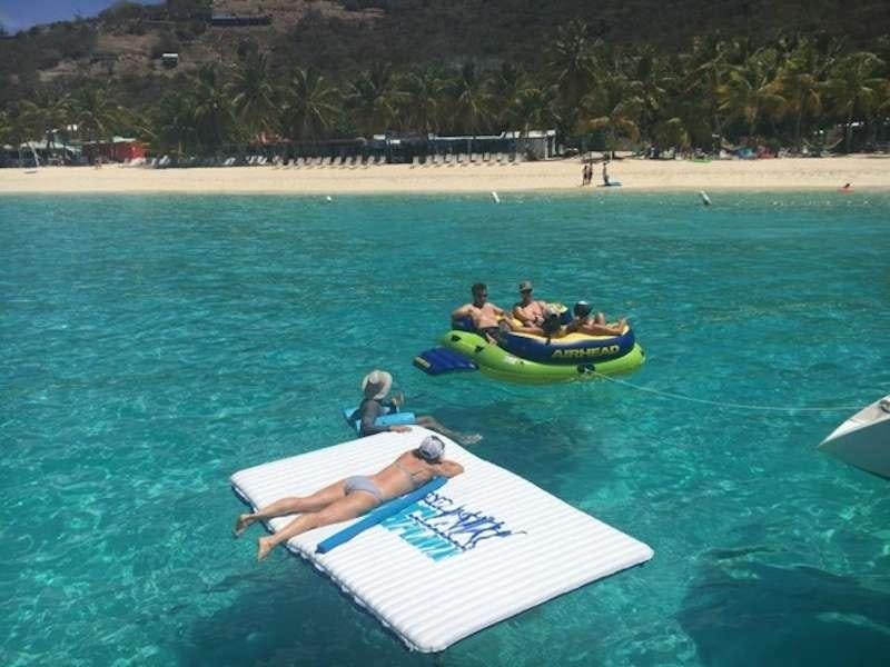 people on a beach aboard FEEL THE MAGIC Yacht for Charter