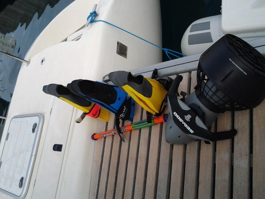 a close-up of a white car with a blue and yellow race car on the track aboard FEEL THE MAGIC Yacht for Charter