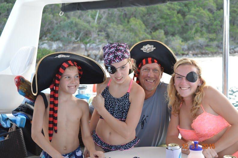 a group of people posing for a photo aboard FEEL THE MAGIC Yacht for Charter