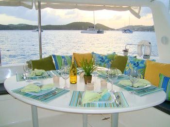 a table with plates and glasses on it aboard FEEL THE MAGIC Yacht for Charter