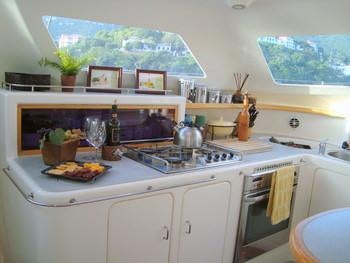 a kitchen with a sink and a stove aboard FEEL THE MAGIC Yacht for Charter
