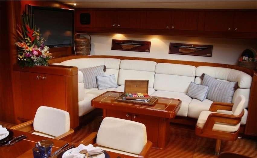 a living room with a couch and a coffee table aboard ASPIRATION Yacht for Charter