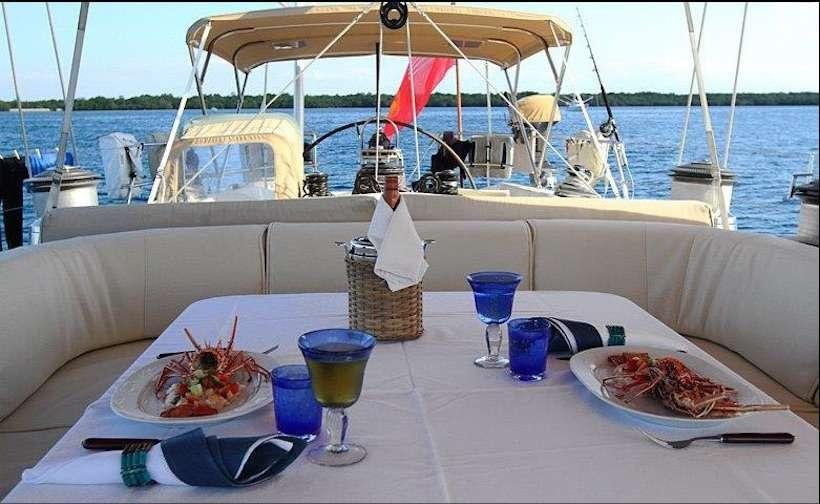 a table with food and drinks on it aboard ASPIRATION Yacht for Charter