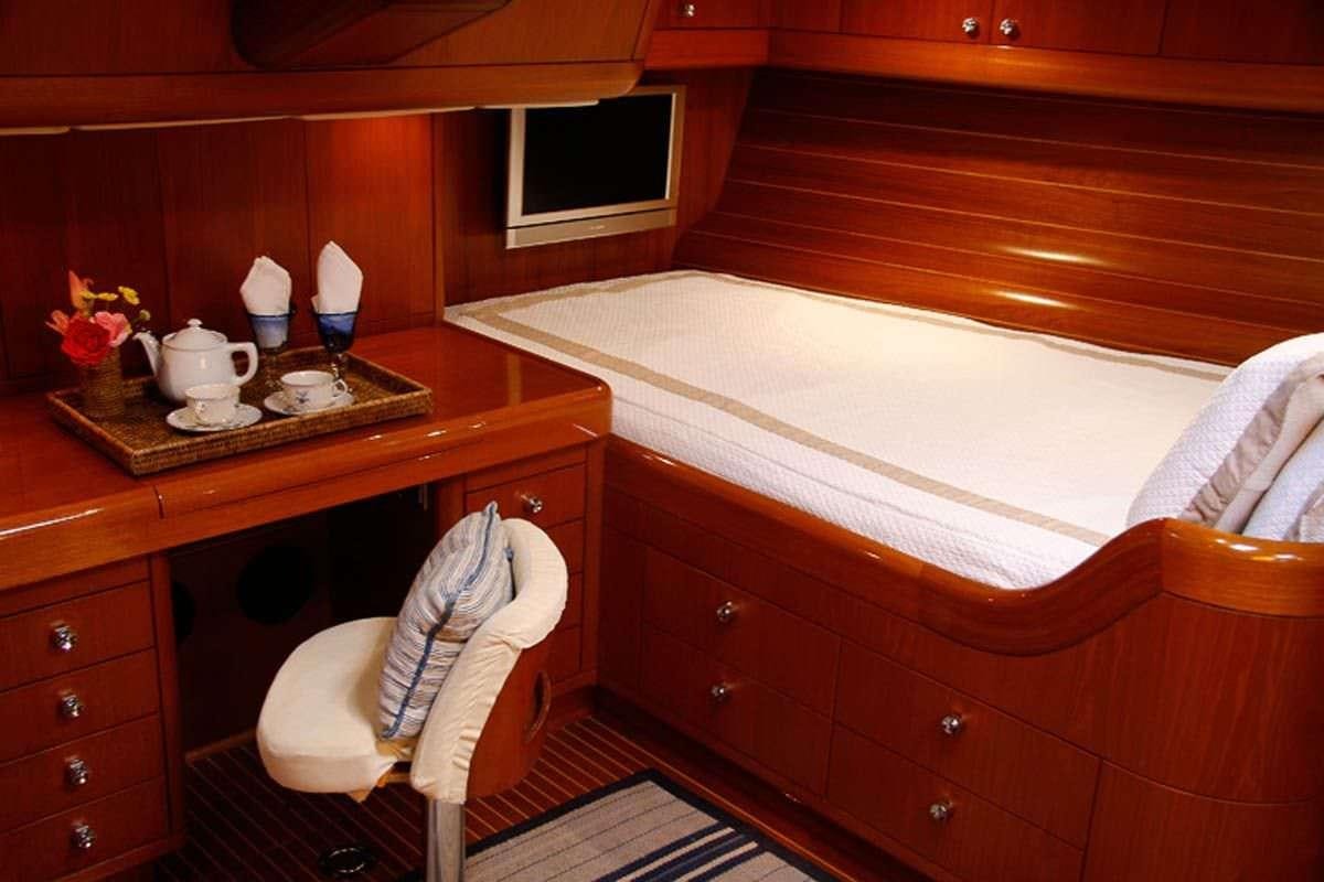 a room with a bed and a table aboard ASPIRATION Yacht for Charter
