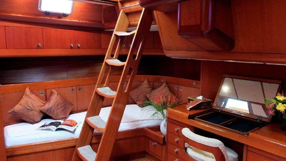 a bunk bed with a desk and a couch aboard ASPIRATION Yacht for Charter