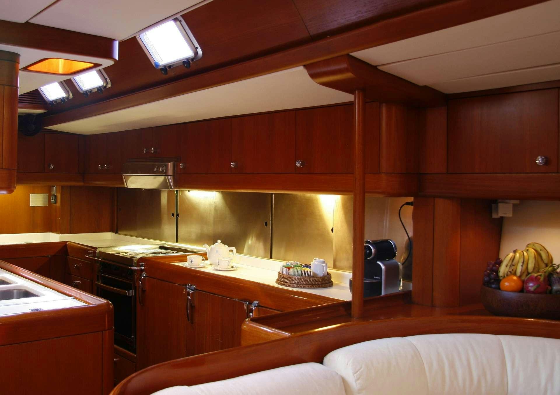a kitchen with wooden cabinets aboard ASPIRATION Yacht for Charter