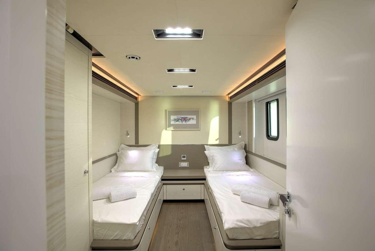 a room with two beds aboard ARCHSEA Yacht for Charter