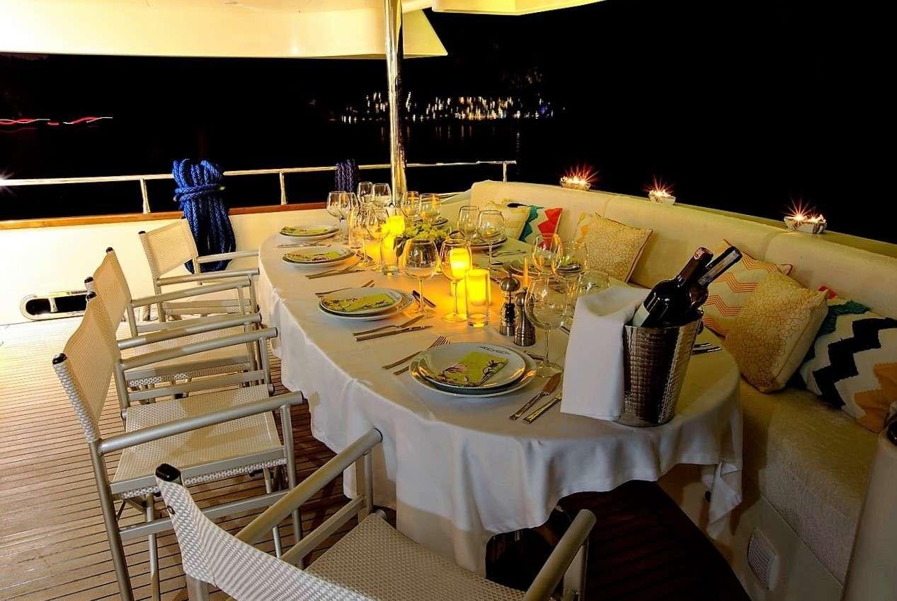 a table set for a dinner party aboard ARCHSEA Yacht for Charter
