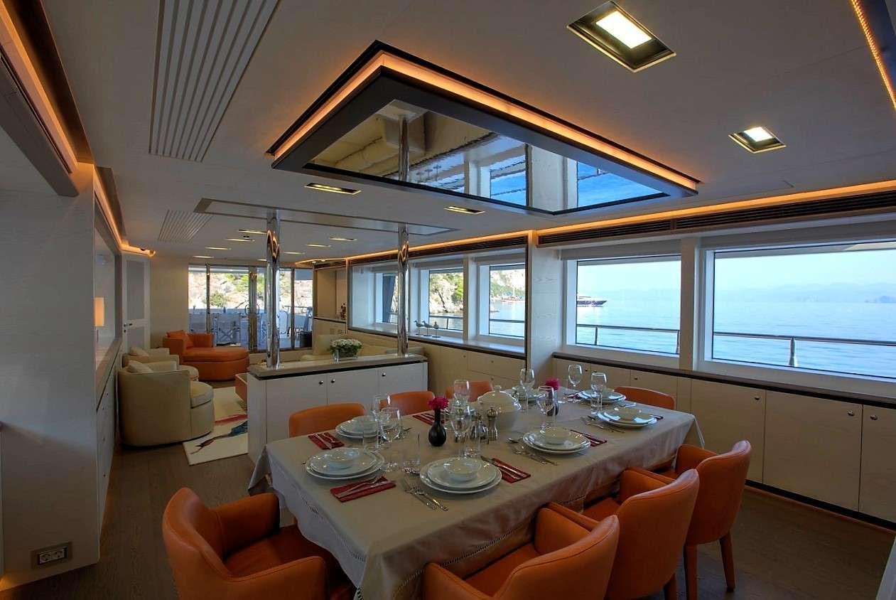 a dining table in a room aboard ARCHSEA Yacht for Charter
