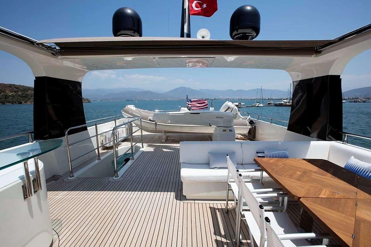 a deck with a view of the ocean and boats aboard ARCHSEA Yacht for Charter