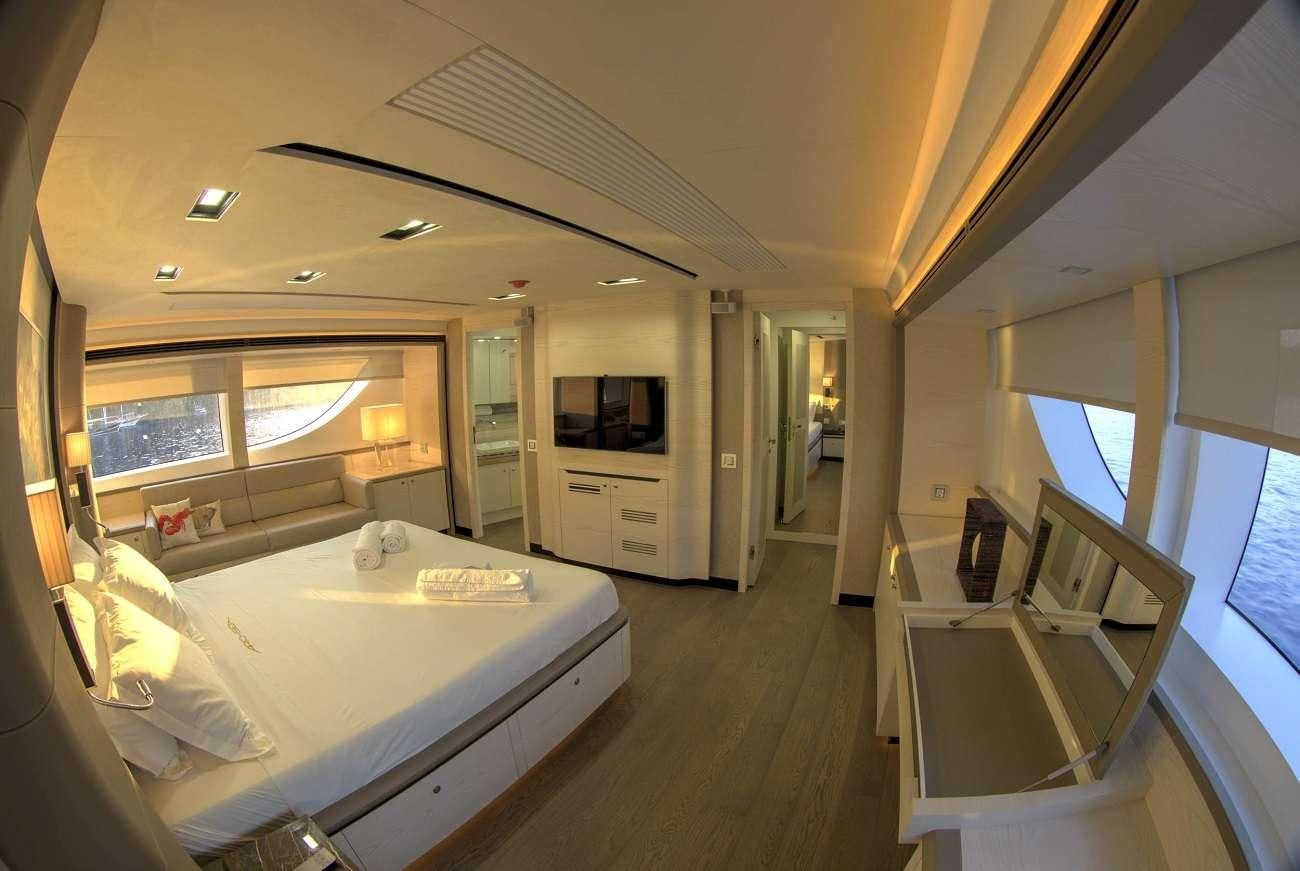 a room with a bed and a table aboard ARCHSEA Yacht for Charter