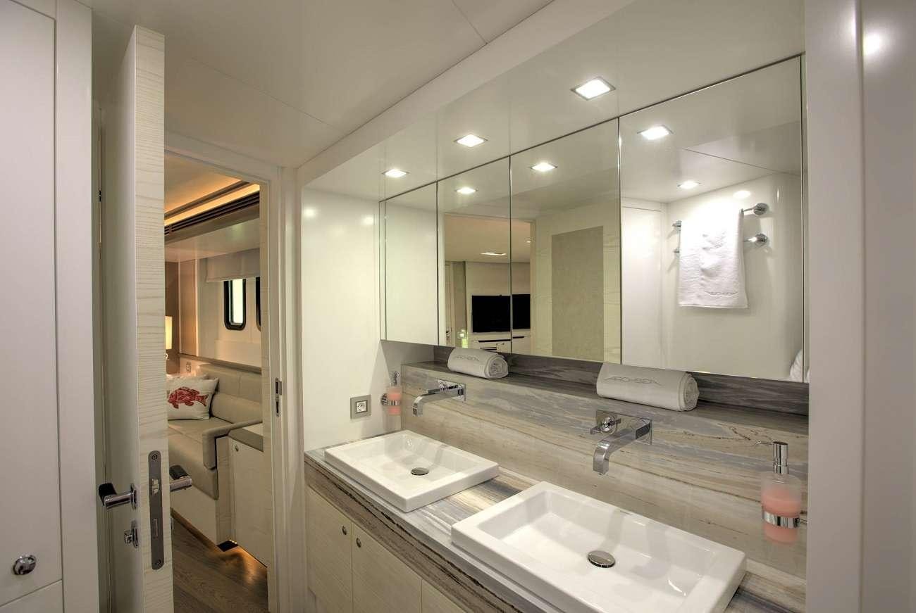 a bathroom with a large mirror aboard ARCHSEA Yacht for Charter