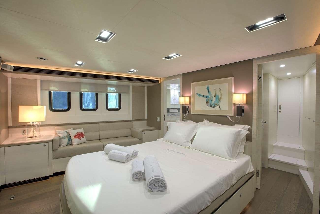 a large white bed in a hotel room aboard ARCHSEA Yacht for Charter