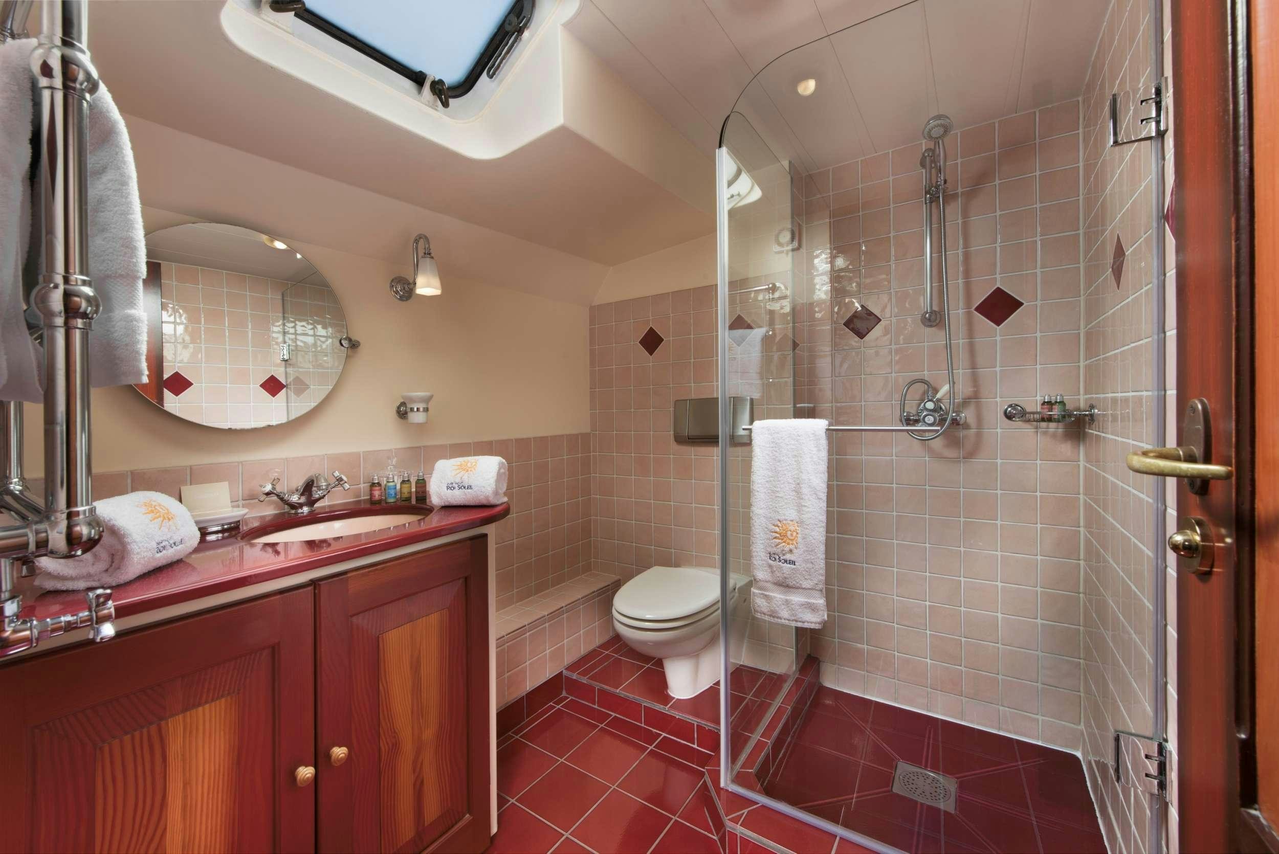 a bathroom with a shower and toilet aboard ROI SOLEIL Yacht for Charter