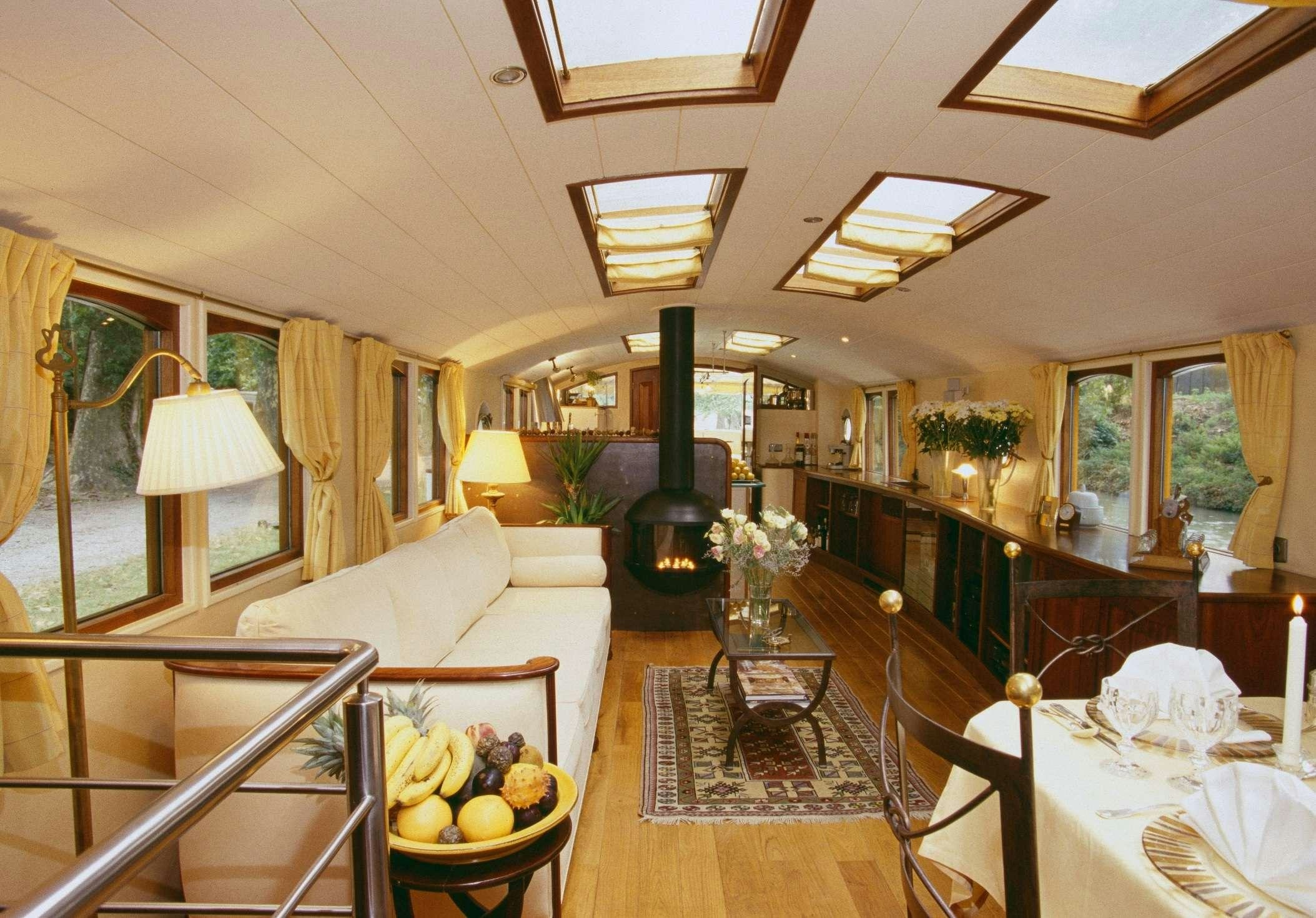 a living room with a large window aboard ROI SOLEIL Yacht for Charter