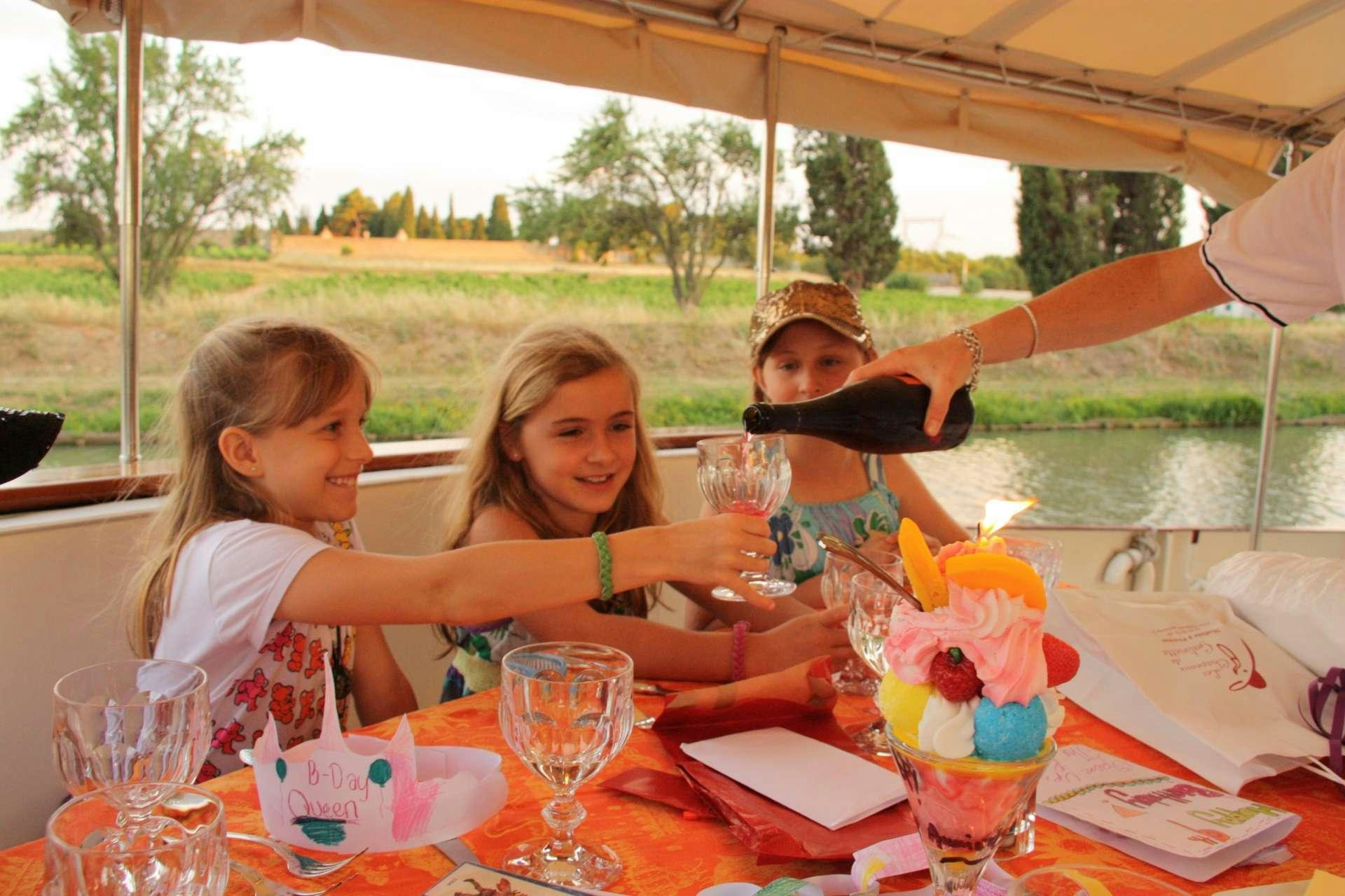 a person pouring a drink into a glass aboard ROI SOLEIL Yacht for Charter