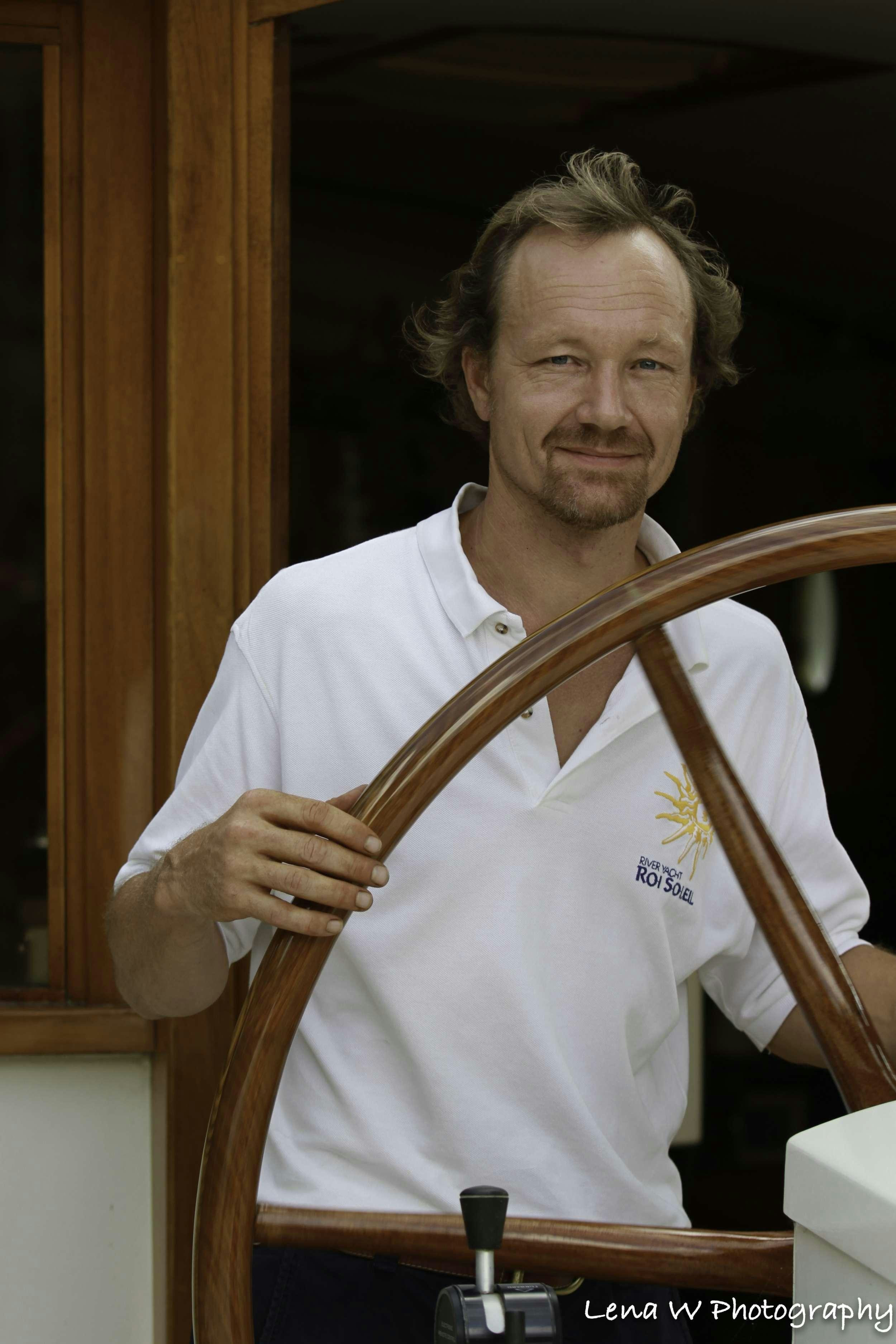 a person holding a large wooden cross aboard ROI SOLEIL Yacht for Charter