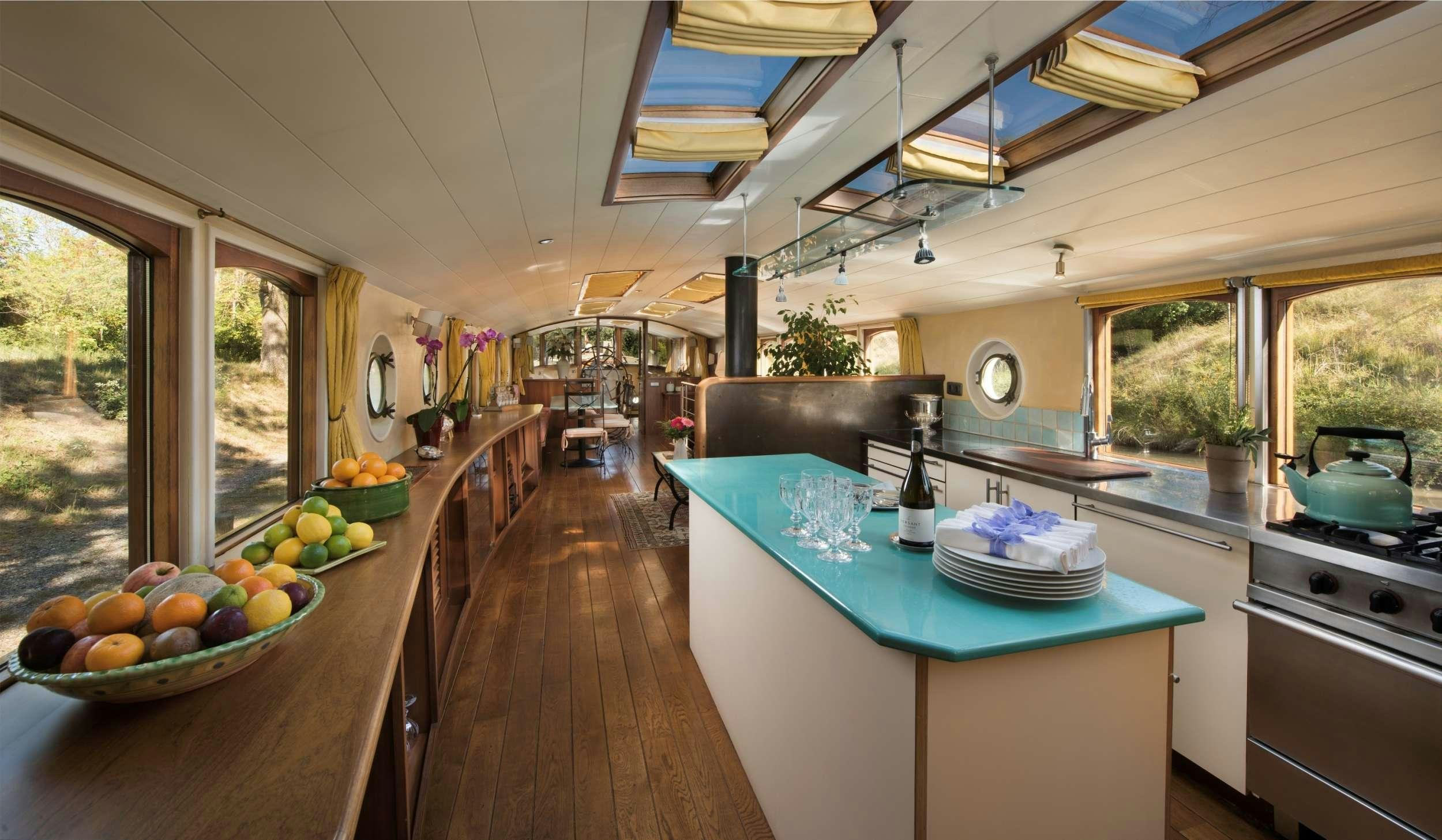 a kitchen with a table and a stove aboard ROI SOLEIL Yacht for Charter