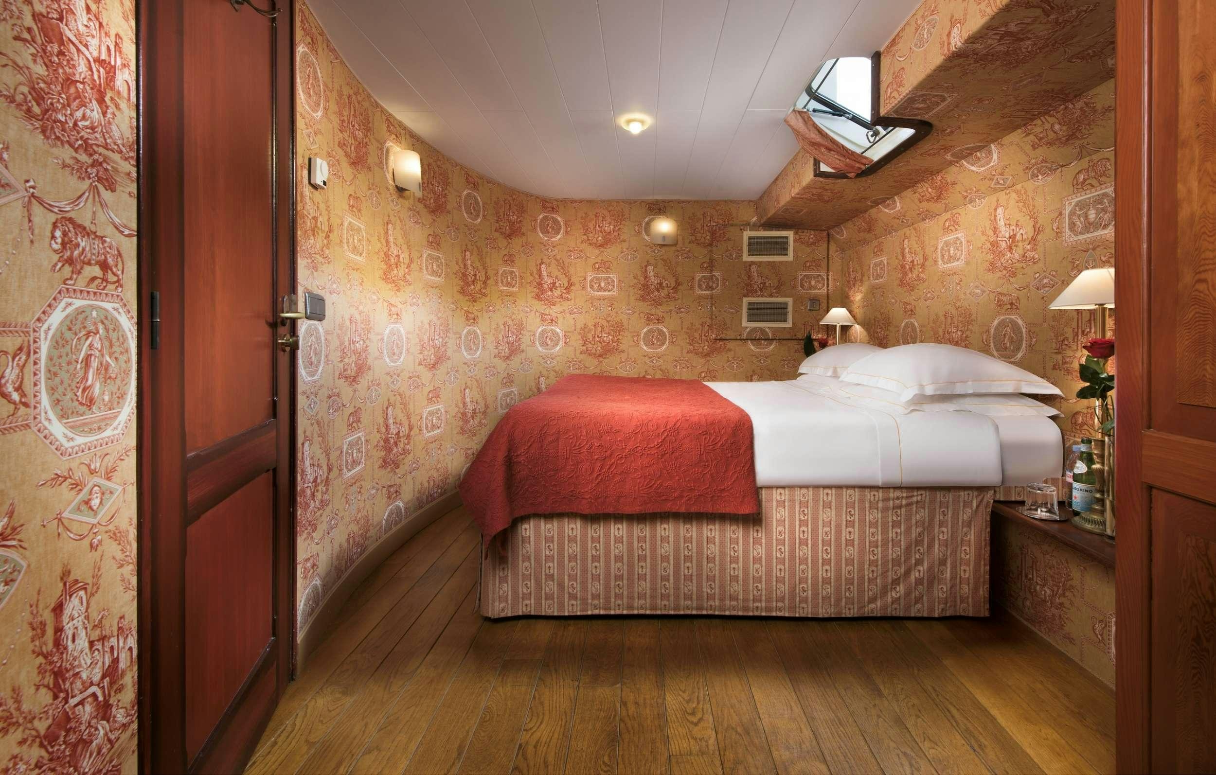 a bedroom with a bed aboard ROI SOLEIL Yacht for Charter