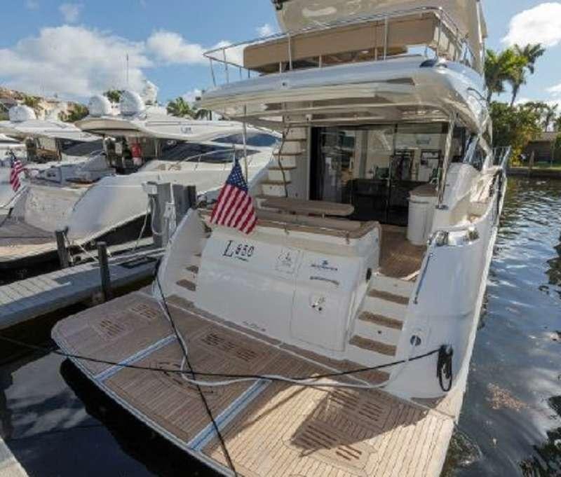 a boat with a flag on the front aboard BETTER BOAT Yacht for Charter