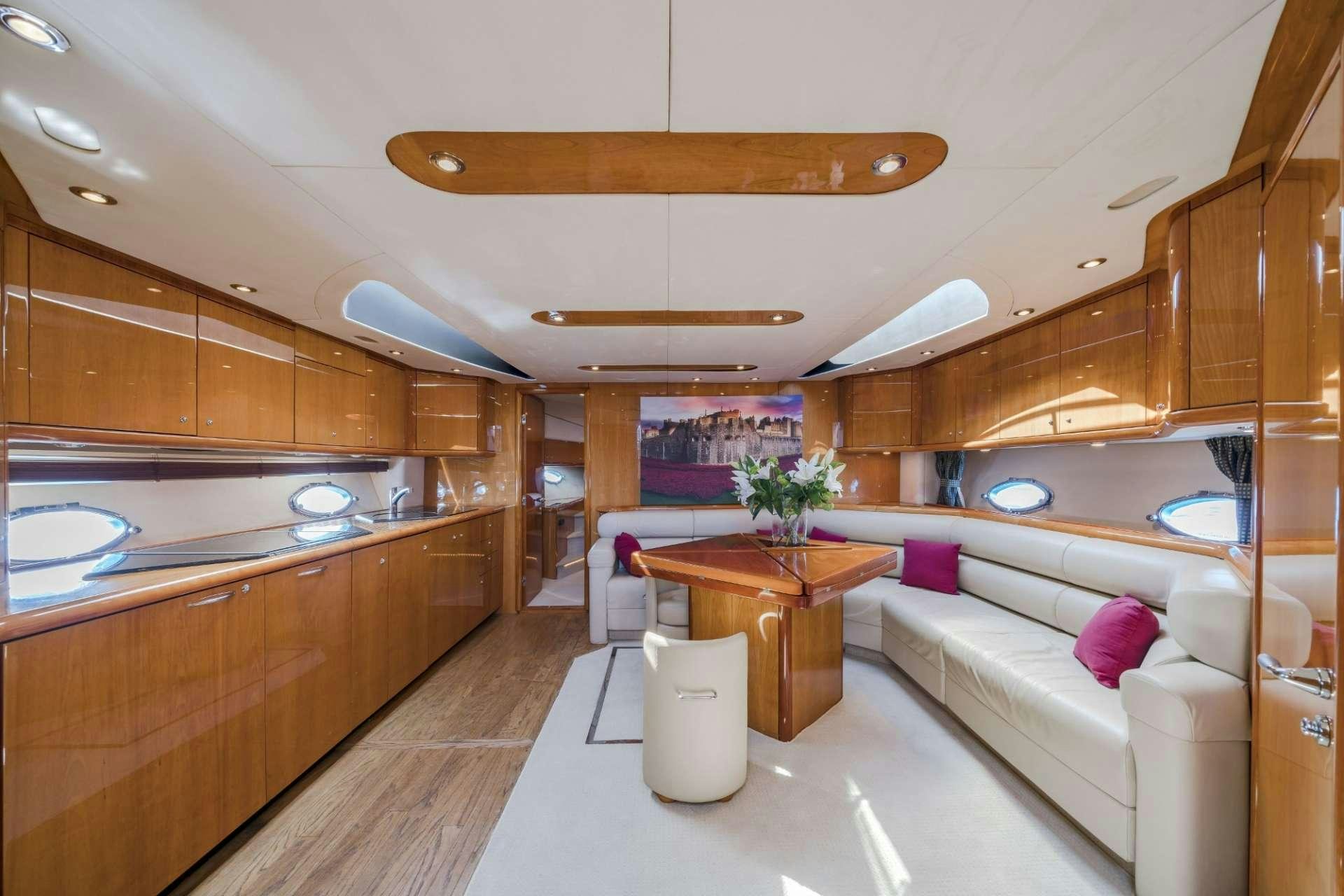 a modern kitchen with wooden cabinets aboard REHAB Yacht for Charter