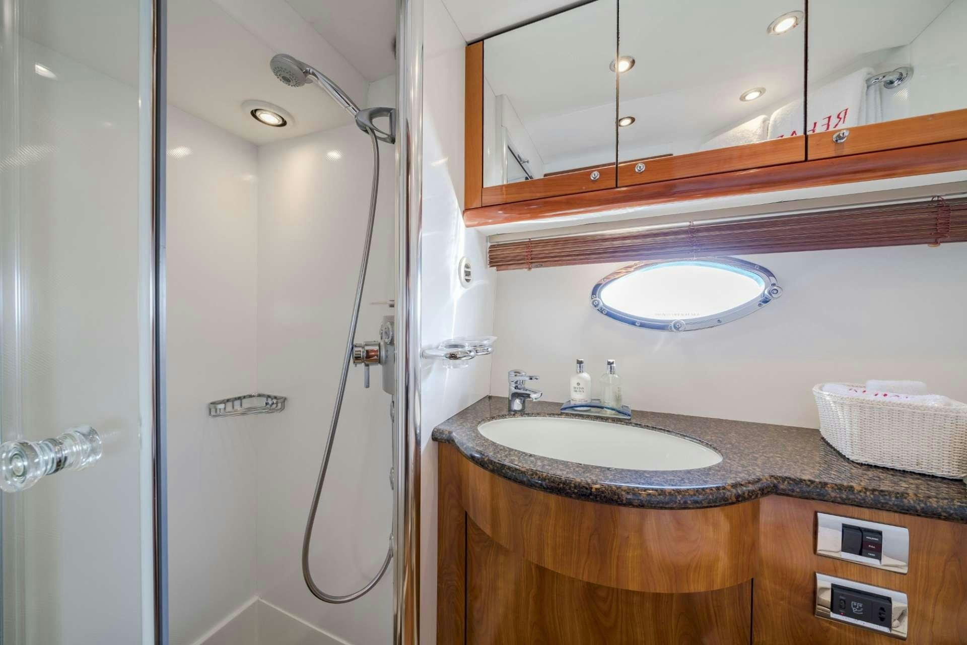a bathroom with a shower and sink aboard REHAB Yacht for Charter