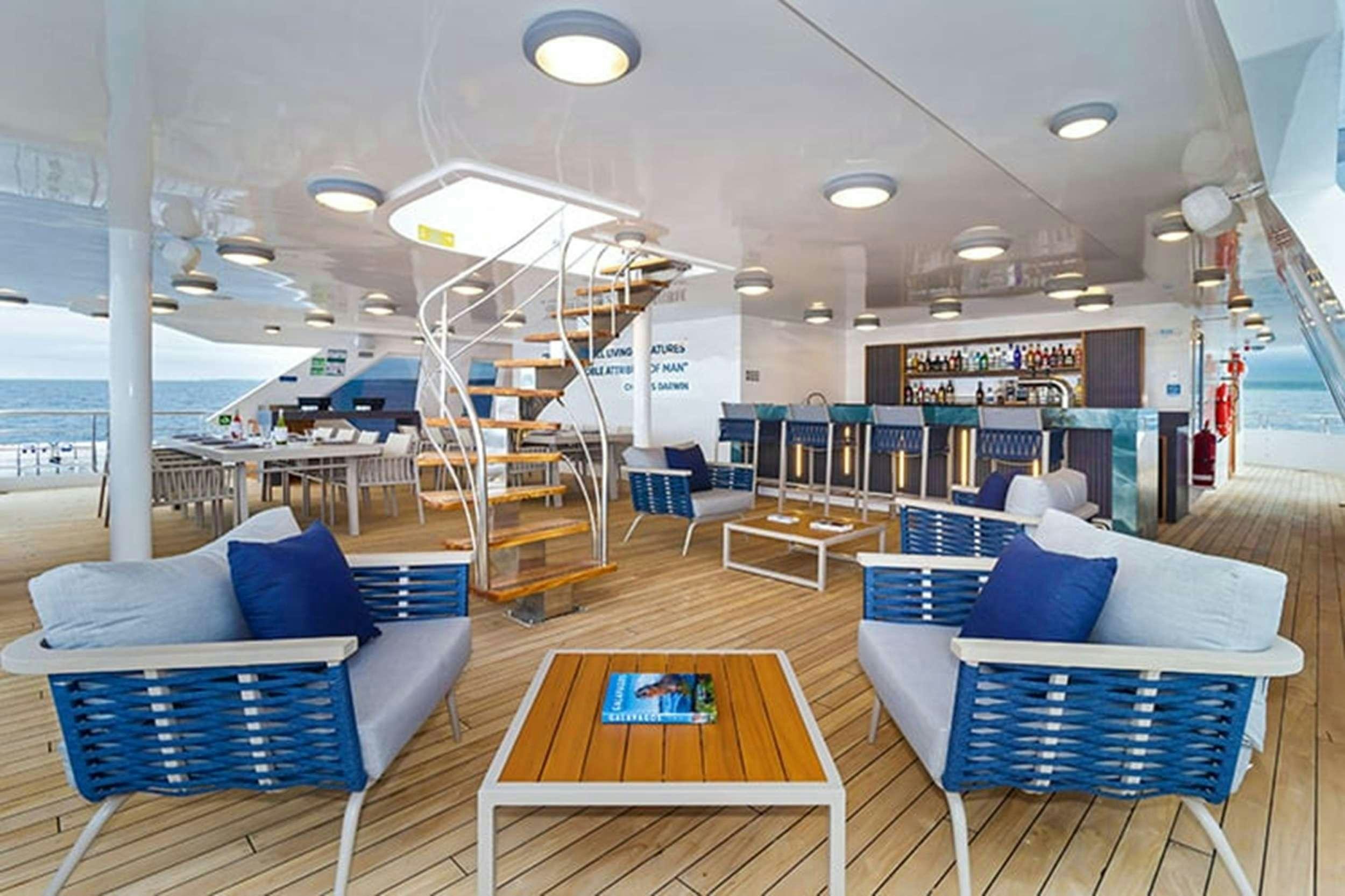 a room with a slide and a pool table aboard CORMORANT II Yacht for Charter