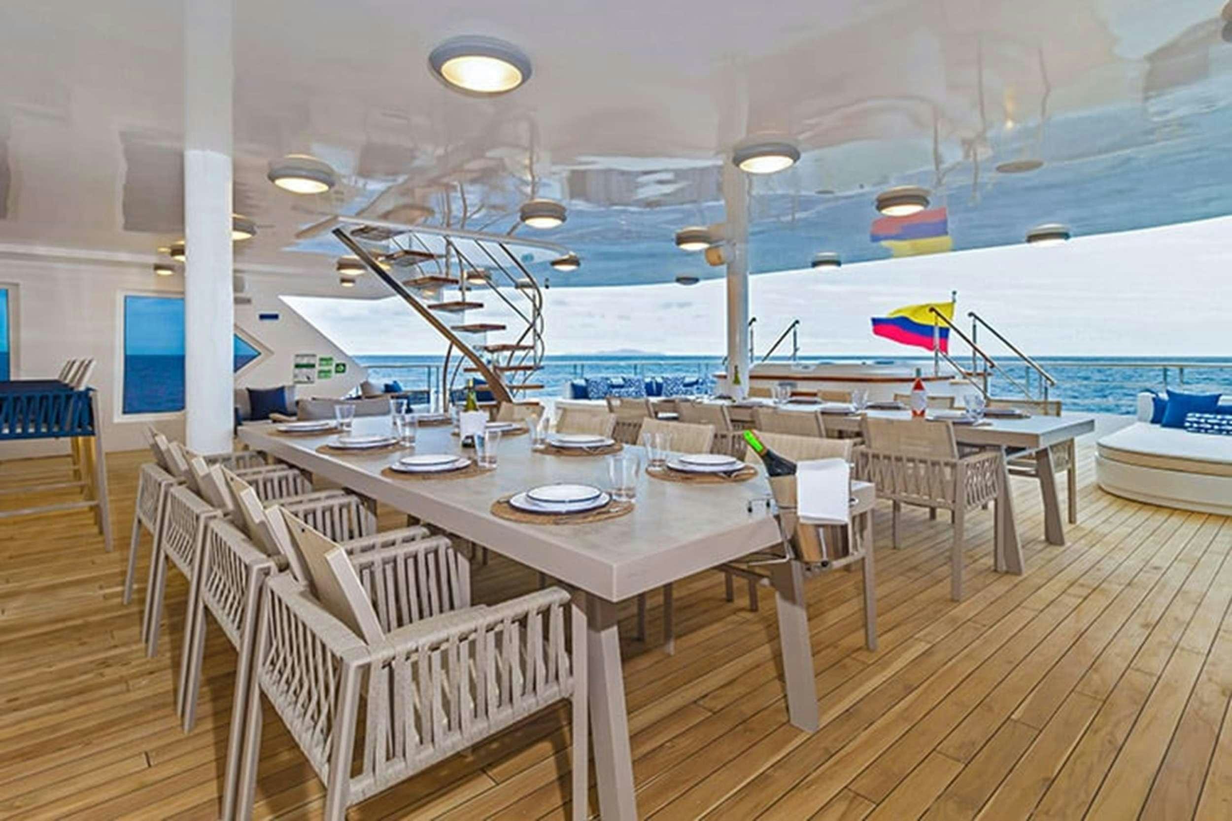 a room with tables and chairs aboard CORMORANT II Yacht for Charter