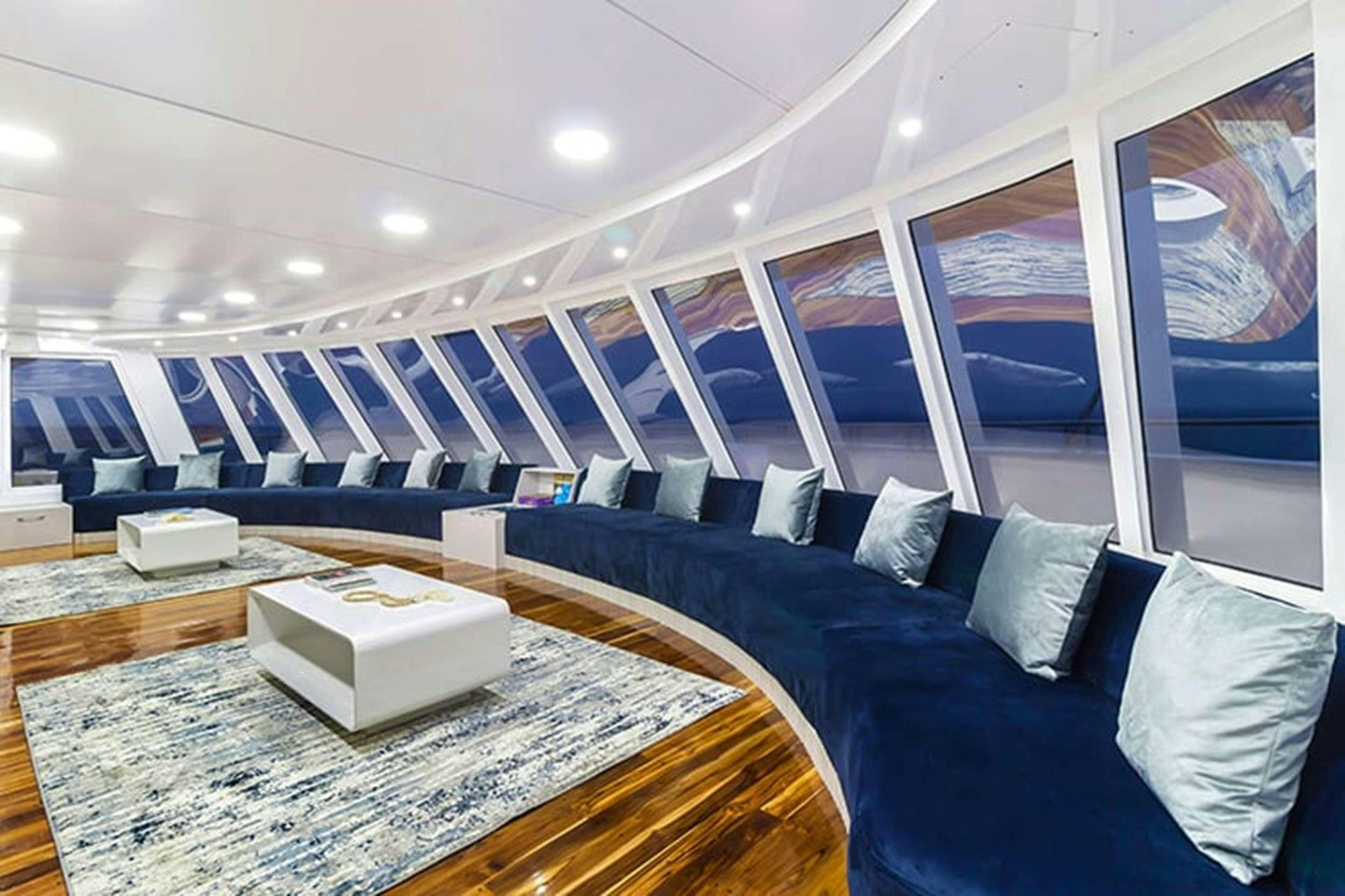 a room with a bed and a couch aboard CORMORANT II Yacht for Charter