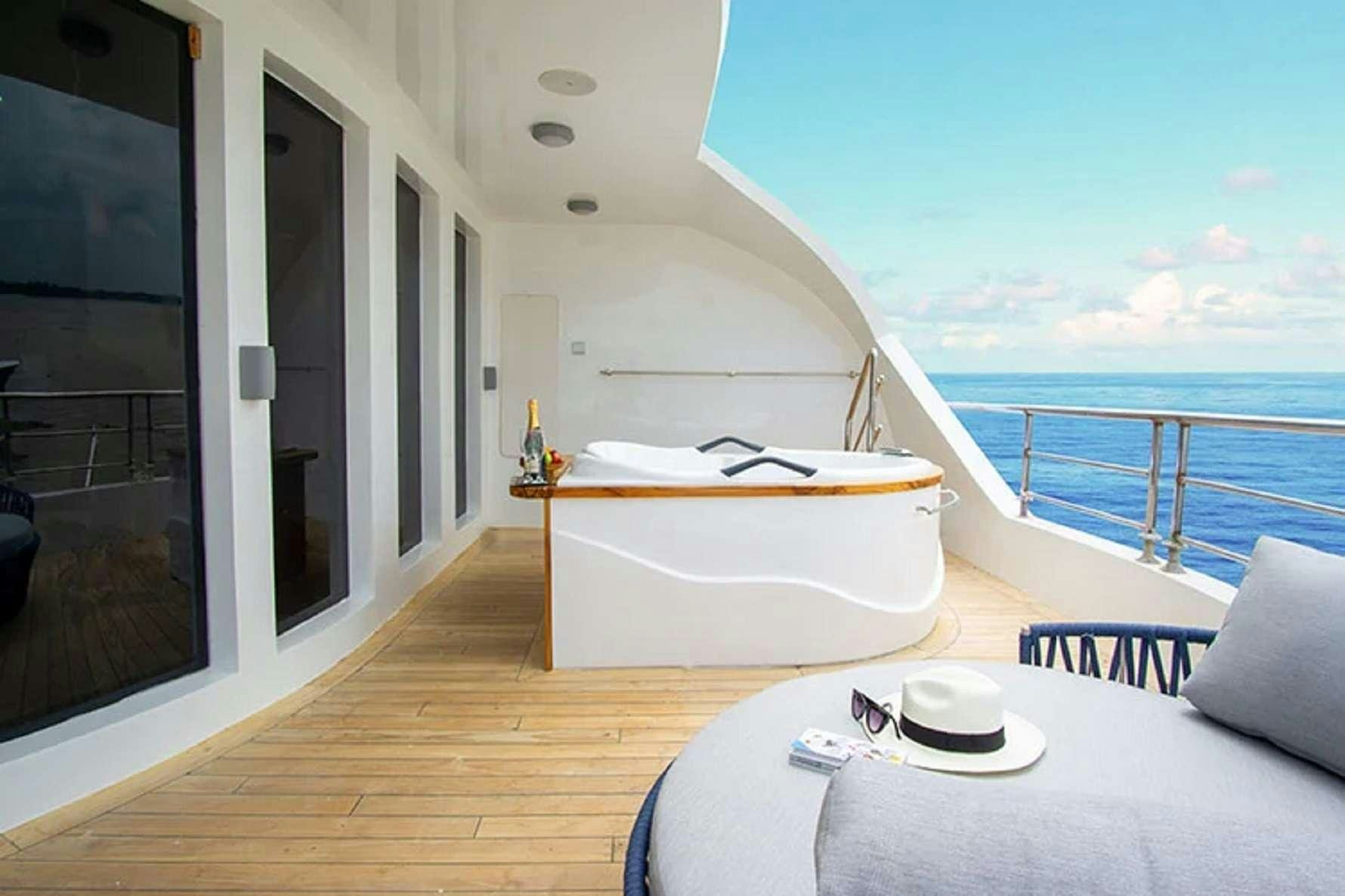 a room with a bed and a table on a boat aboard CORMORANT II Yacht for Charter