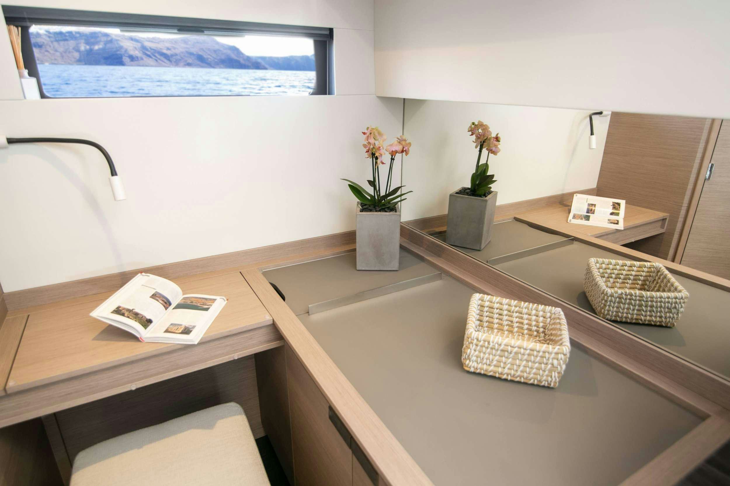 a counter with a plant and a window aboard ALOIA  Yacht for Charter