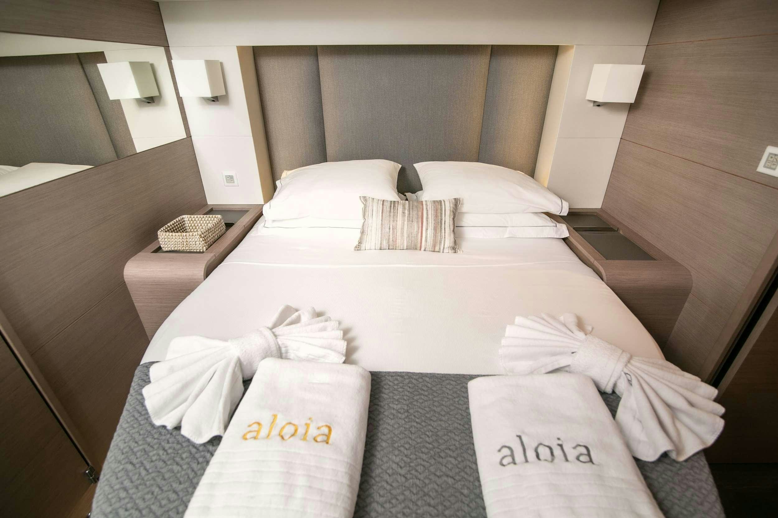 a bed with pillows and pillows aboard ALOIA  Yacht for Charter