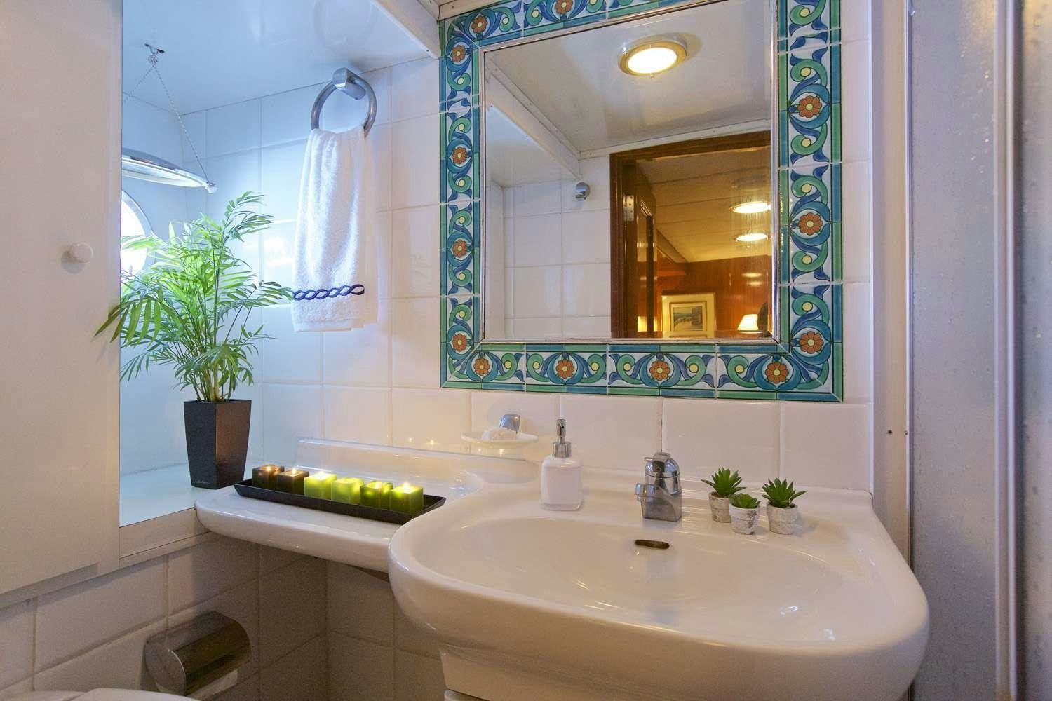 a bathroom with a large mirror aboard HERMINA Yacht for Charter