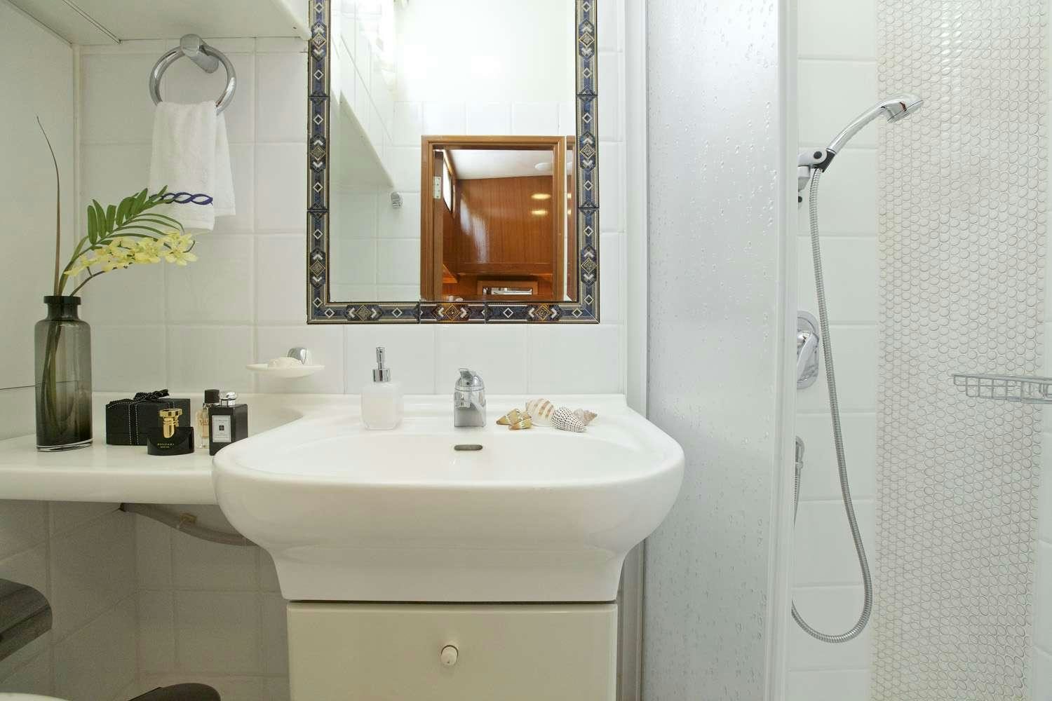 a bathroom with a sink and a mirror aboard HERMINA Yacht for Charter