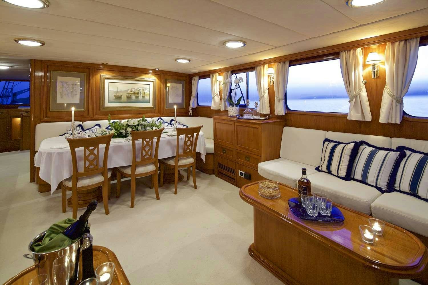 a living room with a table and chairs aboard HERMINA Yacht for Charter