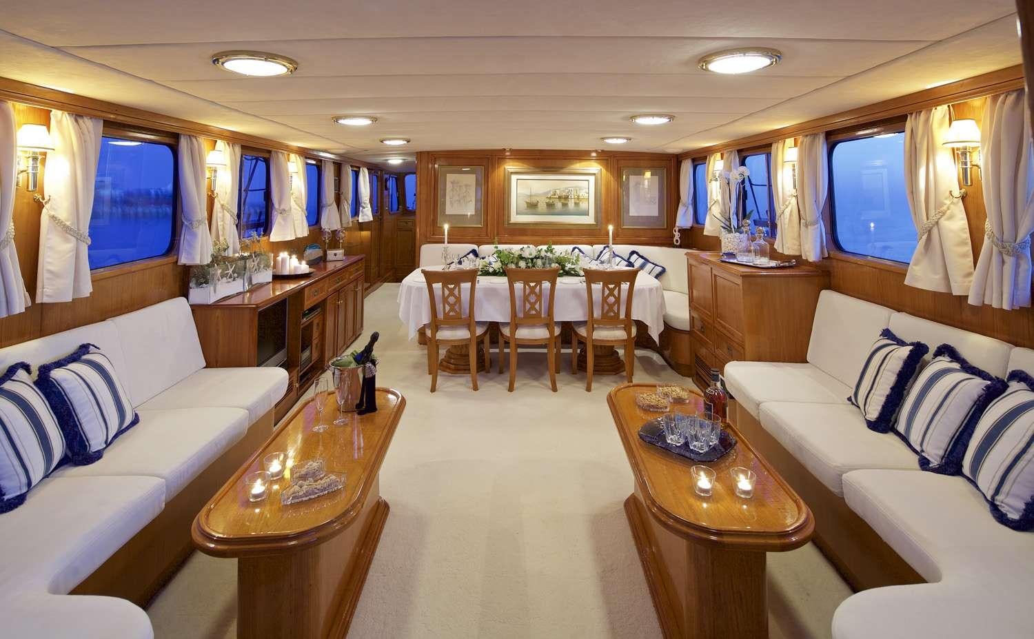 a living room with a table and chairs aboard HERMINA Yacht for Charter