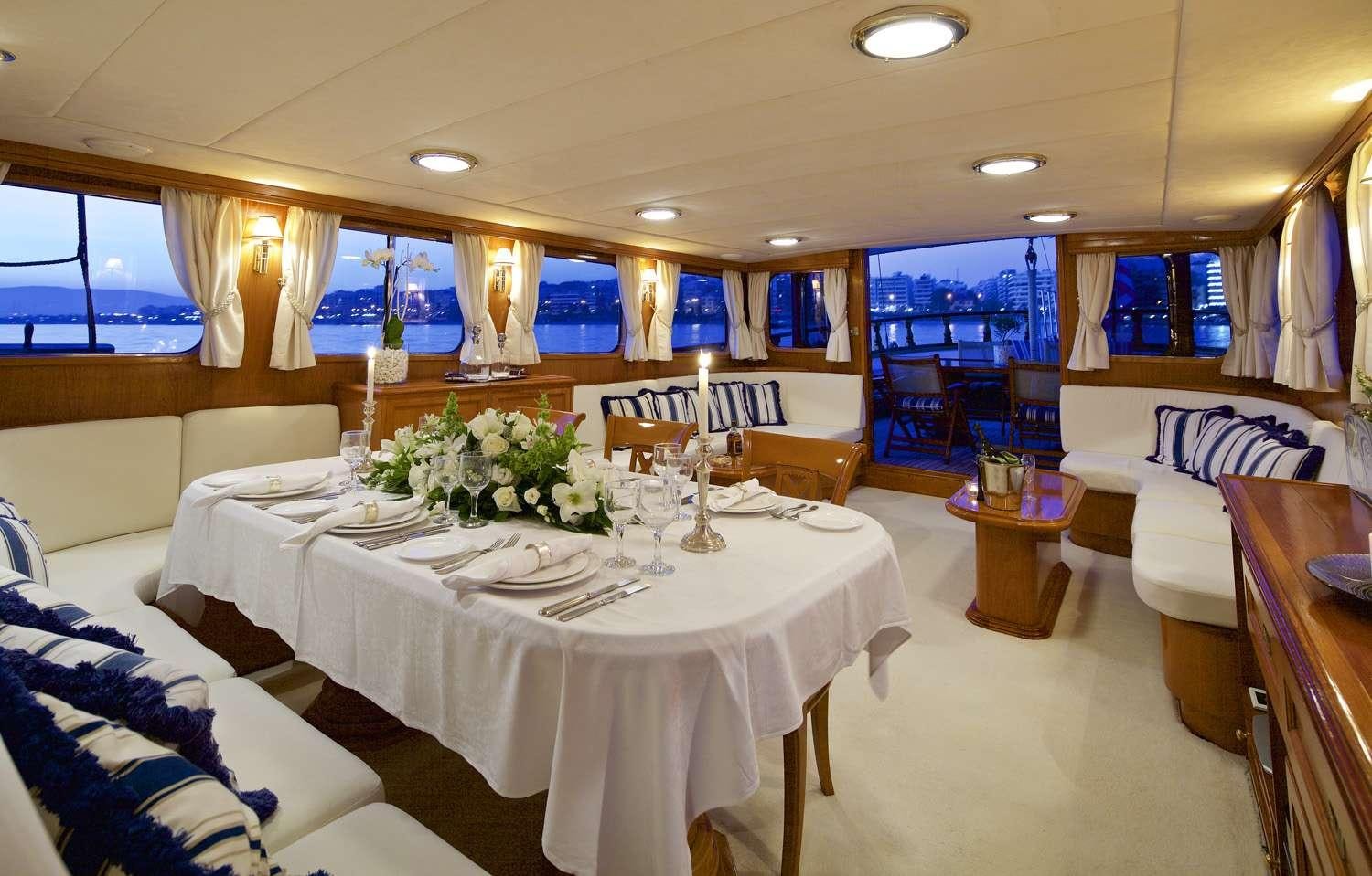 a room with tables and chairs aboard HERMINA Yacht for Charter