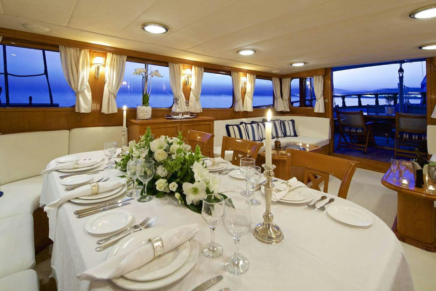 a table set for a formal dinner aboard HERMINA Yacht for Charter