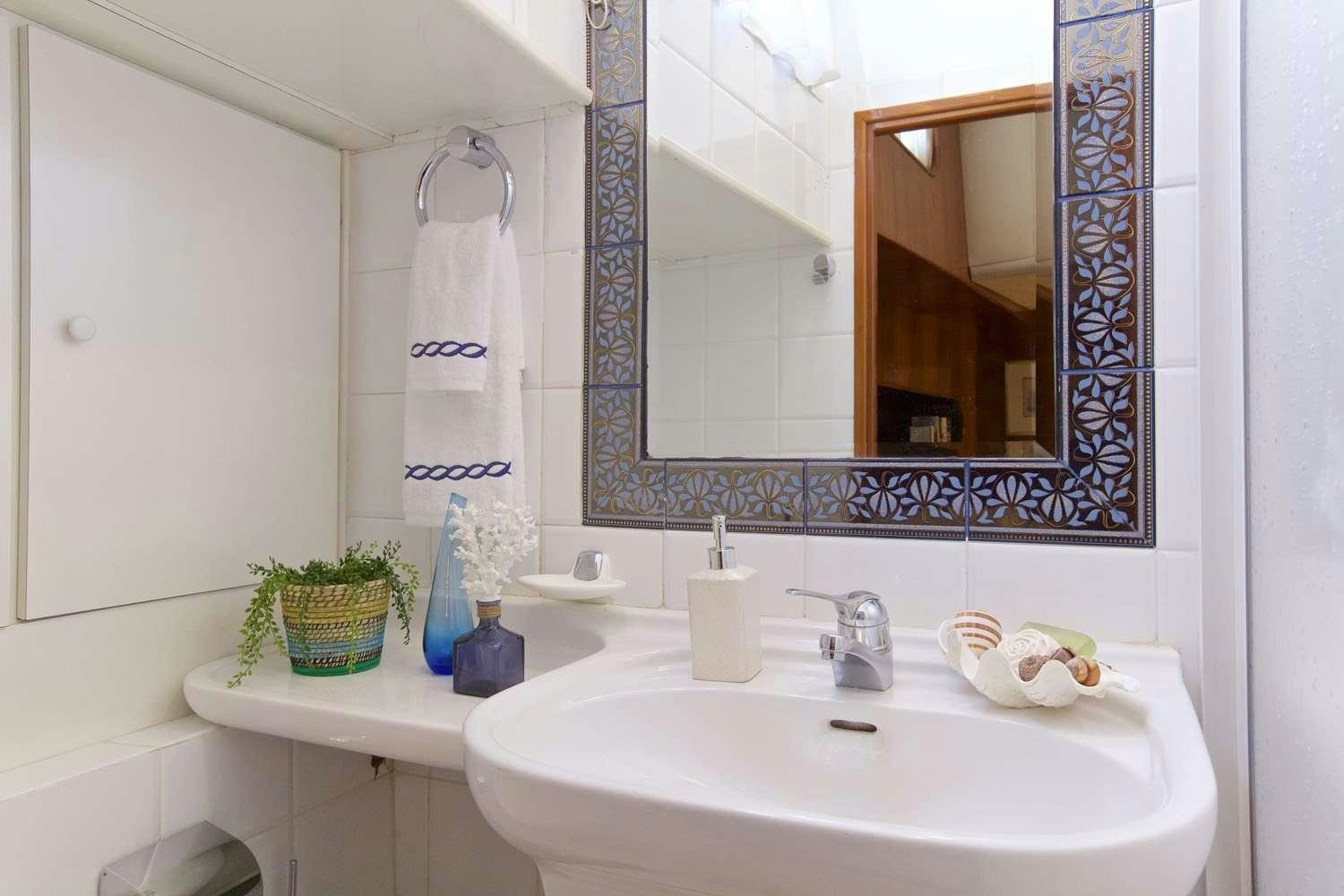 a bathroom with a sink and mirror aboard HERMINA Yacht for Charter