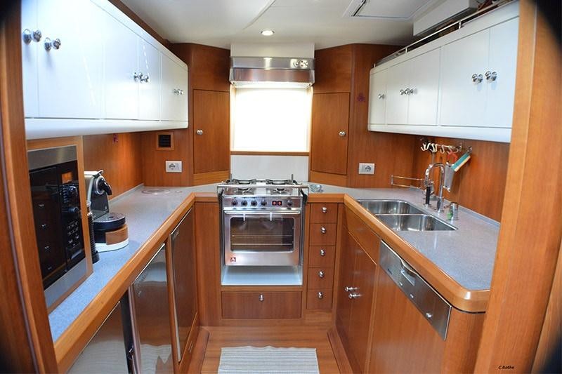 a kitchen with wooden cabinets aboard TERRA DI MEZZO 3 Yacht for Charter
