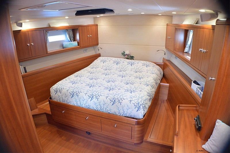 a bedroom with wooden furniture aboard TERRA DI MEZZO 3 Yacht for Charter