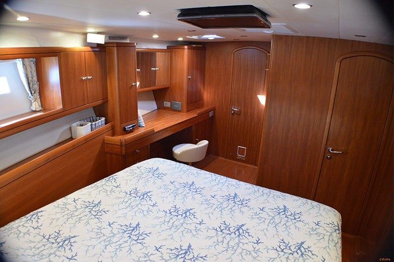 a large bedroom with a large bed aboard TERRA DI MEZZO 3 Yacht for Charter