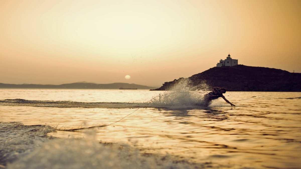 a person surfing on the waves aboard KEPI Yacht for Charter
