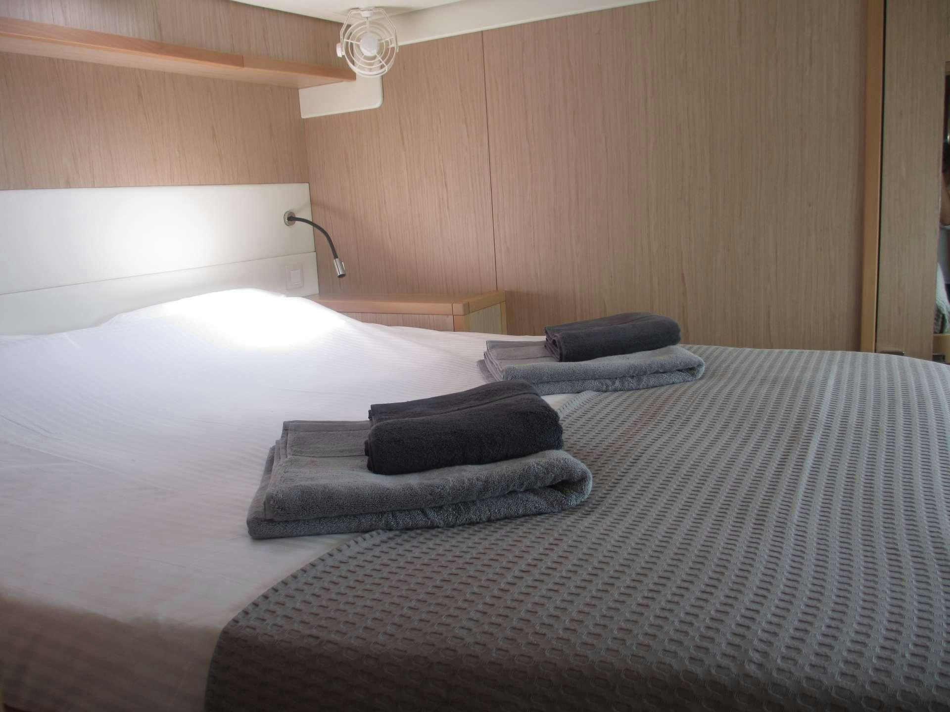 a bed with pillows aboard KEPI Yacht for Charter