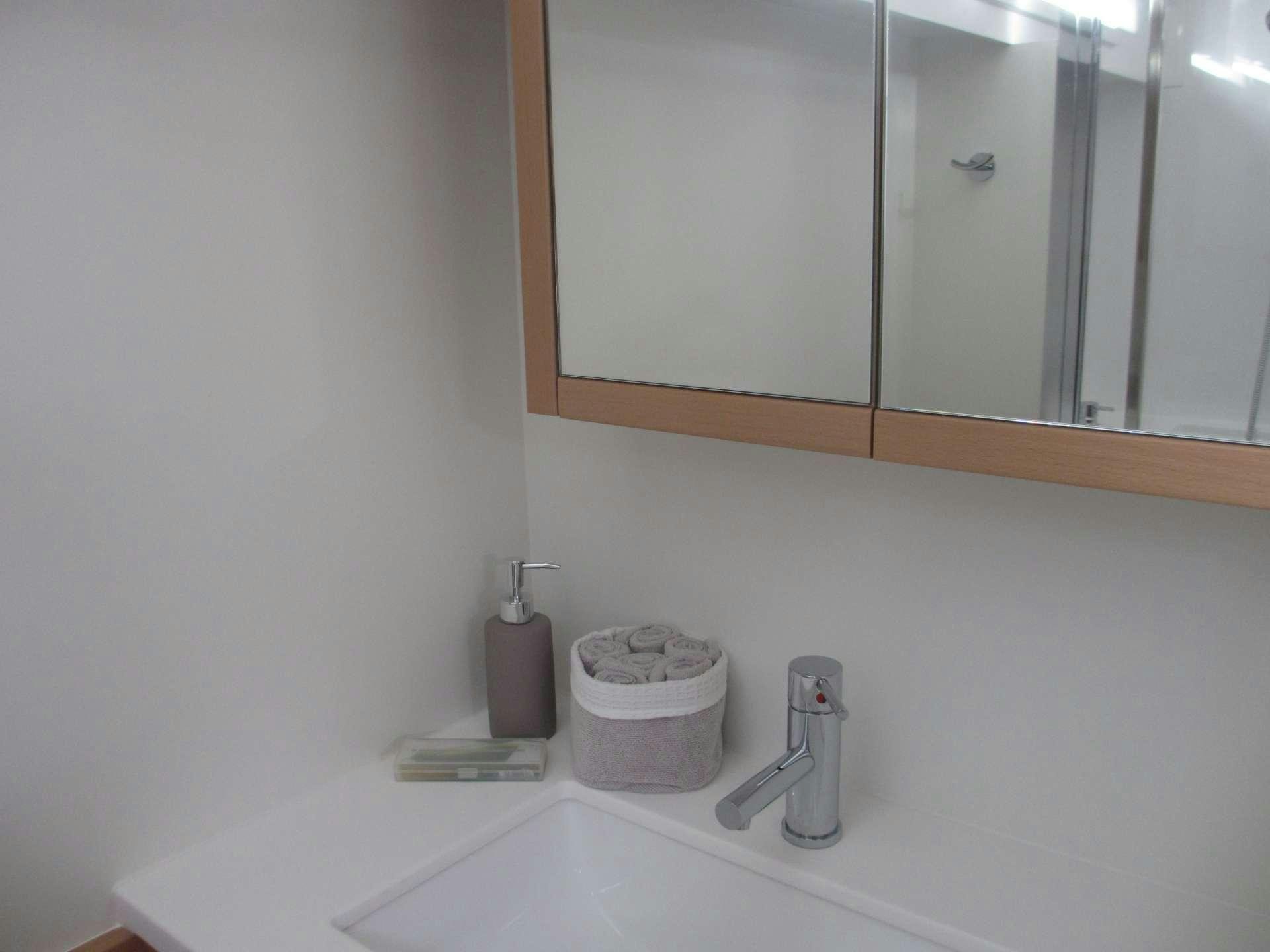 a bathroom with a mirror and a sink aboard KEPI Yacht for Charter